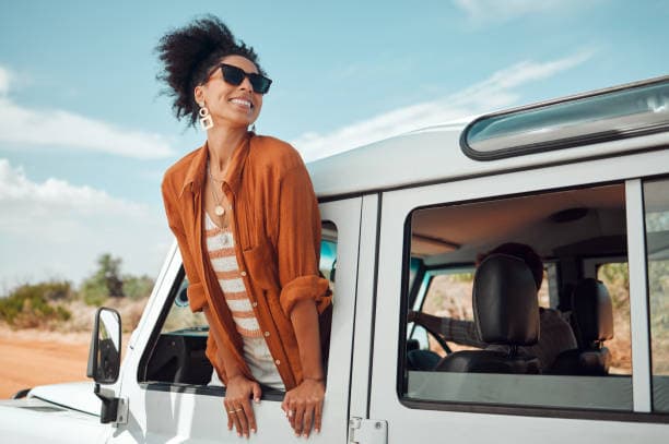 Person in orange outfit near a white van